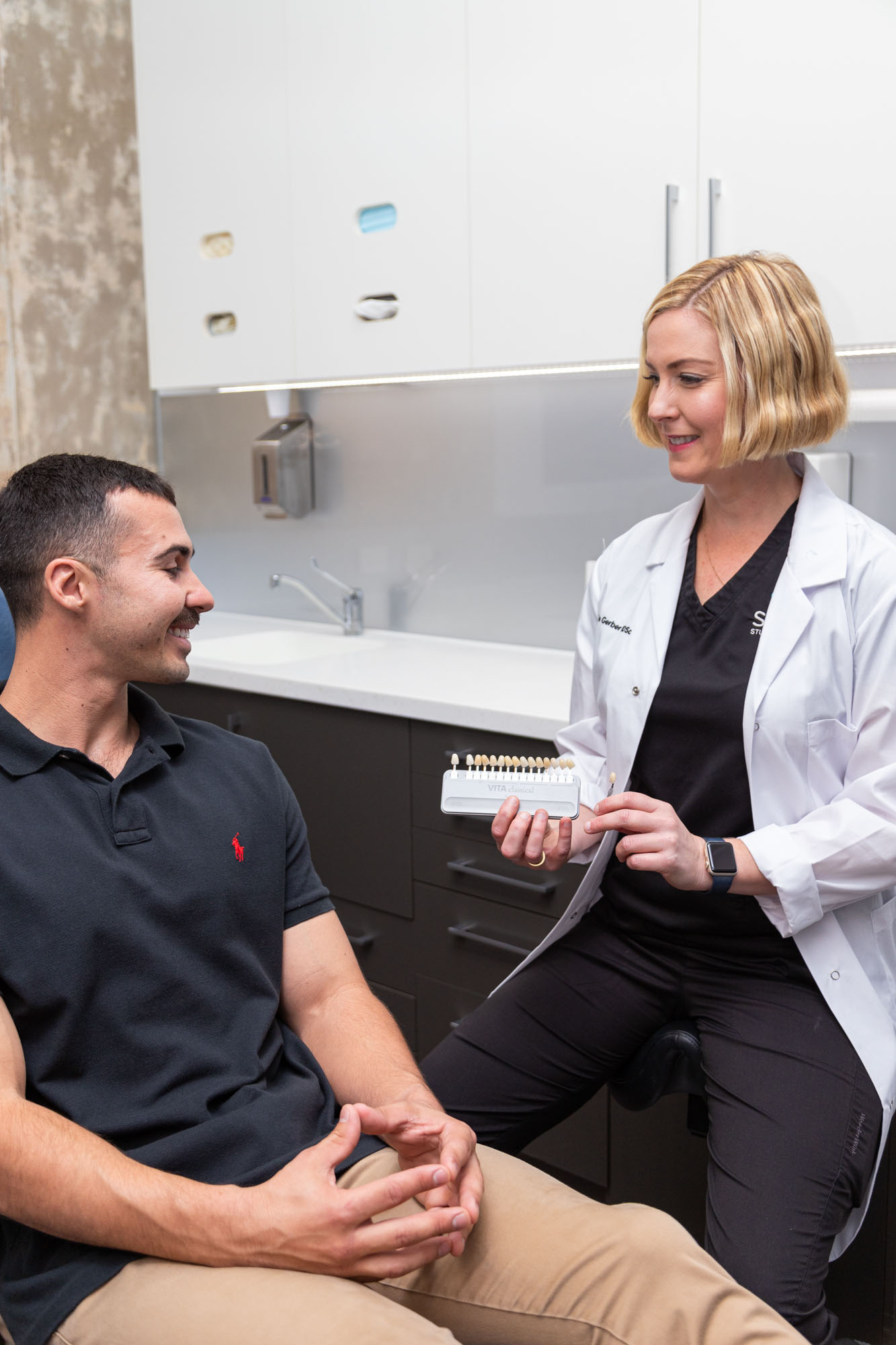 Dentist with patient in a detailed dental examination.
