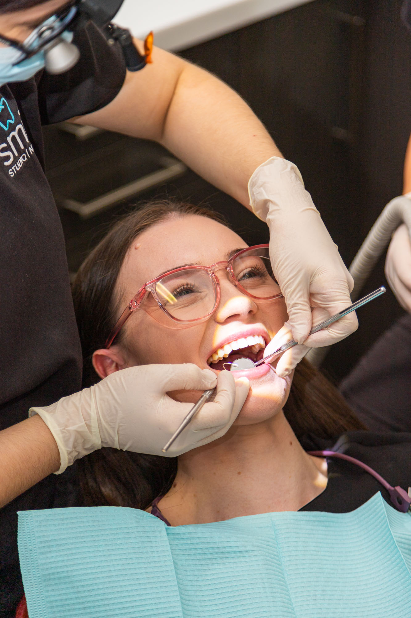 Dentist giving a patient a Clean, Scale & Polish.
